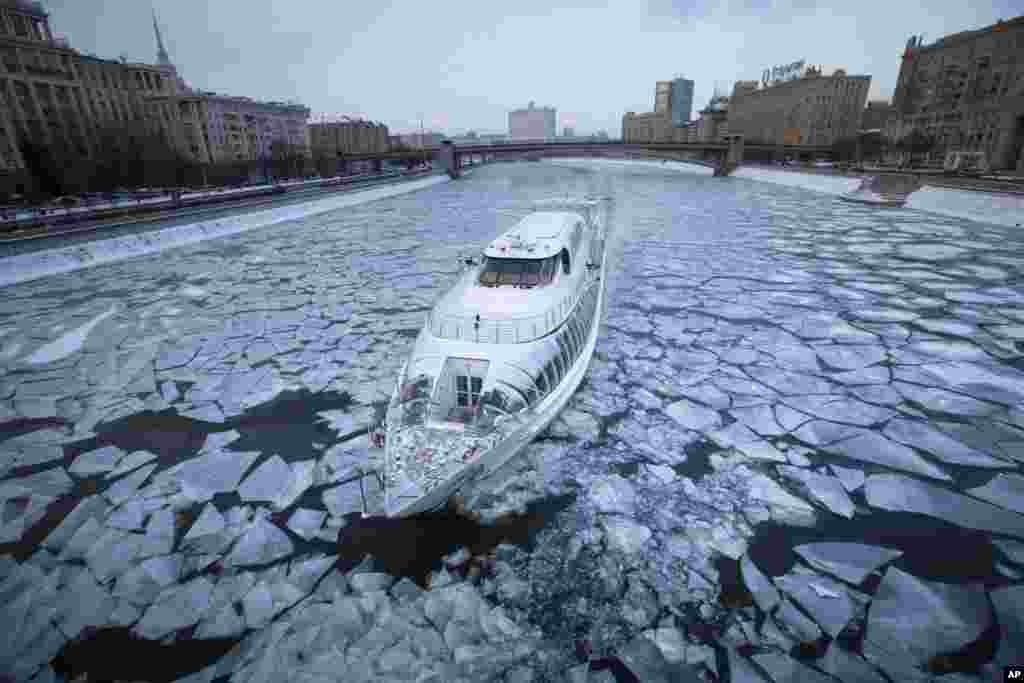 A tourist boat cruises the frozen Moskva River in Moscow, Russia. Temperatures dipped to -18° C (-0.4° F) in Moscow and -20 C (-4° F) in surrounding regions.