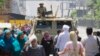An army soldier stands alert over an armored vehicle near Nahda Square, where supporters of Egypt's ousted President Mohammed Morsi have installed their camp near Cairo University in Giza, southwestern Cairo, Egypt, Aug. 12, 2013. 