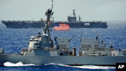 FILE - The USS Chung-Hoon guided-missile destroyer, front, and the USS Nimitz aircraft carrier are underway during the Great Green Fleet demonstration portion of the Rim of the Pacific (RIMPAC) 2012 exercise, July 18, 2012.