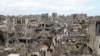 Palestinians walk past the rubble of buildings destroyed during the Israeli offensive, on a rainy day in Gaza City amid a ceasefire between Israel and Hamas, Feb. 6, 2025. 