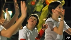 A child with Down's syndrome (C) participates in a performance during a humanitarian concert for children with Down's syndrome, (File)