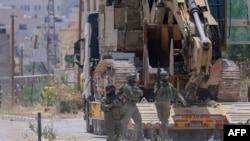 TOPSHOT - Israeli forces storm the Palestinian refugee camp of Jenin in the occupied West Bank on May 21, 2024, in what the military said was a "counterterrorism operation", without providing further details.