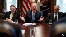 FILE - Secretary of State Mike Pompeo, left, and Secretary of Defense Jim Mattis, right, listen as President Donald Trump speaks during a cabinet meeting at the White House, June 21, 2018. (AP Photo/Evan Vucci)