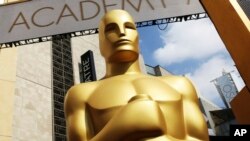 FILE - An Oscar statue appears outside the Dolby Theatre for the 87th Academy Awards in Los Angeles. The Academy of Motion Picture Arts and Sciences is trying to open access to the entertainment business for people from underrepresented communities. Acade