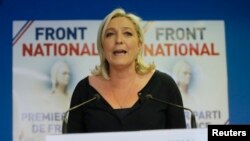 Marine Le Pen, France's National Front political party head, reacts to results after the polls closed in the European Parliament elections at the party's headquarters in Nanterre, near Paris, May 25, 2014. 