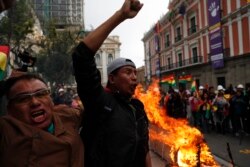 Opponents of Bolivia's President Evo Morales celebrate after he announced his resignation in La Paz, Bolivia, Nov. 10, 2019.