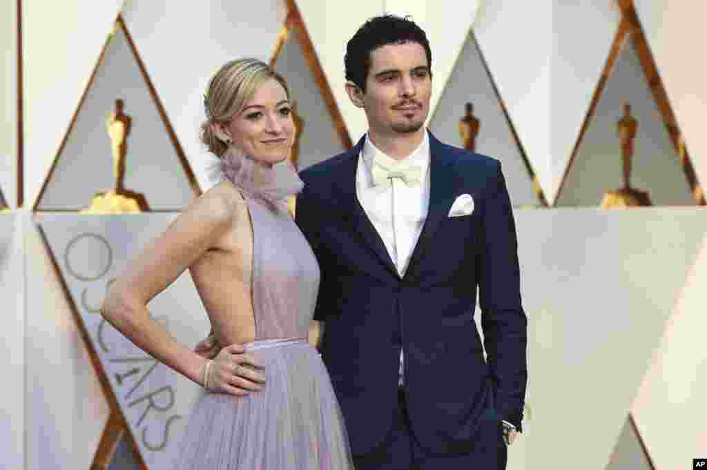 Olivia Hamilton, left, and Damien Chazelle arrive at the Oscars on Sunday, Feb. 26, 2017, at the Dolby Theatre in Los Angeles.