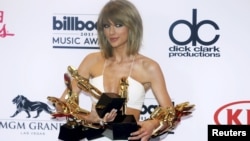 Singer Taylor Swift poses backstage with her awards for Top Artist, Billboard Chart Achievement Award, Top Female Artist, Top Hot 100 Artist, Top Digital Songs Artist, Top Streaming Song (Video) for "Shake it Off" and Top Billboard 200 Album for "1989" during the 2015 Billboard Music Awards in Las Vegas, Nevada, May 17, 2015.