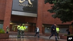Police officers and safety personnel stand at the entrance of the Centro Andino shopping center after and explosion rocked the building, in Bogota, Colombia, June 17, 2017.