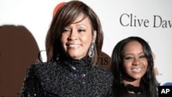 FILE - Whitney Houston and daughter Bobbi Kristina in Beverly Hills, California.