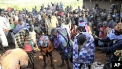 People gather around teenage girls from Uganda's Sebei tribe who have just undergone female genital mutilation in Bukwa district, about 357 kms (214 miles) northeast of Kampala (File Photo).