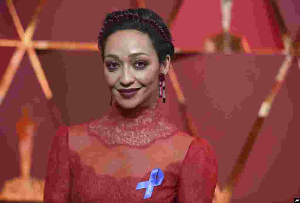 Ruth Negga, wearing the ACLU ribbon, arrives at the Oscars on Sunday, Feb. 26, 2017, at the Dolby Theatre in Los Angeles.