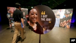 FILE - In this May 19, 2017, file photo, job seekers walk into the Opportunity Fair and Forum employment event in Dallas.
