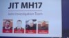 FILE - Russian nationals Igor Girkin, Sergey Dubinskiy and Oleg Pulatov, as well as Ukrainian Leonid Kharchenko, accused of downing of flight MH17, seen on screen as international investigators present their findings in Nieuwegein, June 19, 2019.