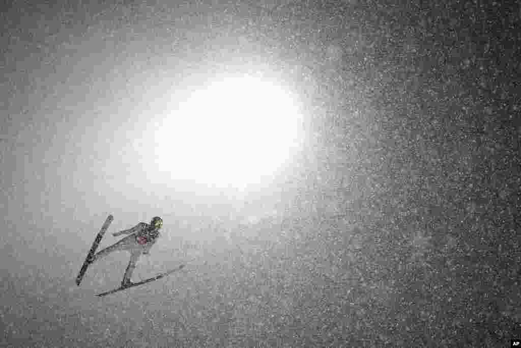 Slovenia's Ziga Jelar soars through the air during the third stage of the 70th Four Hills ski jumping tournament in Bischofshofen, Austria.