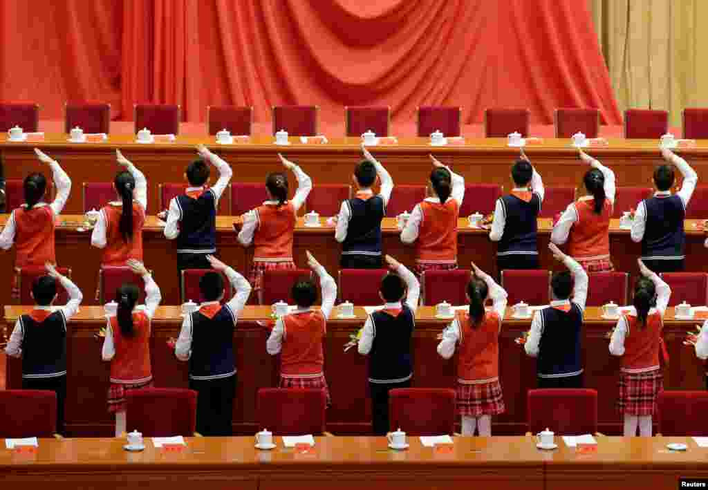 Students prepare for an event marking the 40th anniversary of China's reform and opening up at the Great Hall of the People in Beijing.