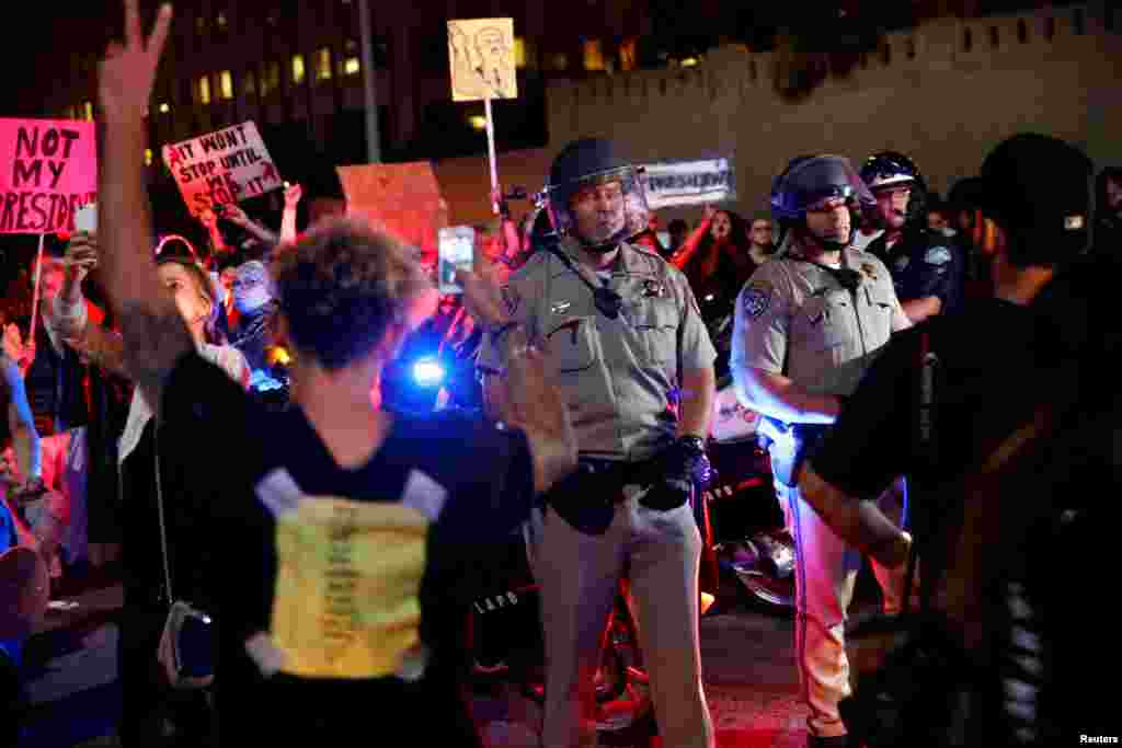 Police are surrounded by demonstrators who took over the Hollywood 101 Freeway just north of Los Angeles City Hall in protest to the election of Republican Donald Trump as President of the United States in Los Angeles, California, Nov. 9, 2016.