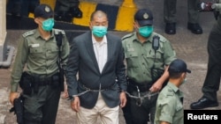 FILE - Media mogul Jimmy Lai Chee-ying, founder of Apple Daily, walks to a prison van to head to court, after being charged under the national security law, in Hong Kong, China, December 12, 2020. 