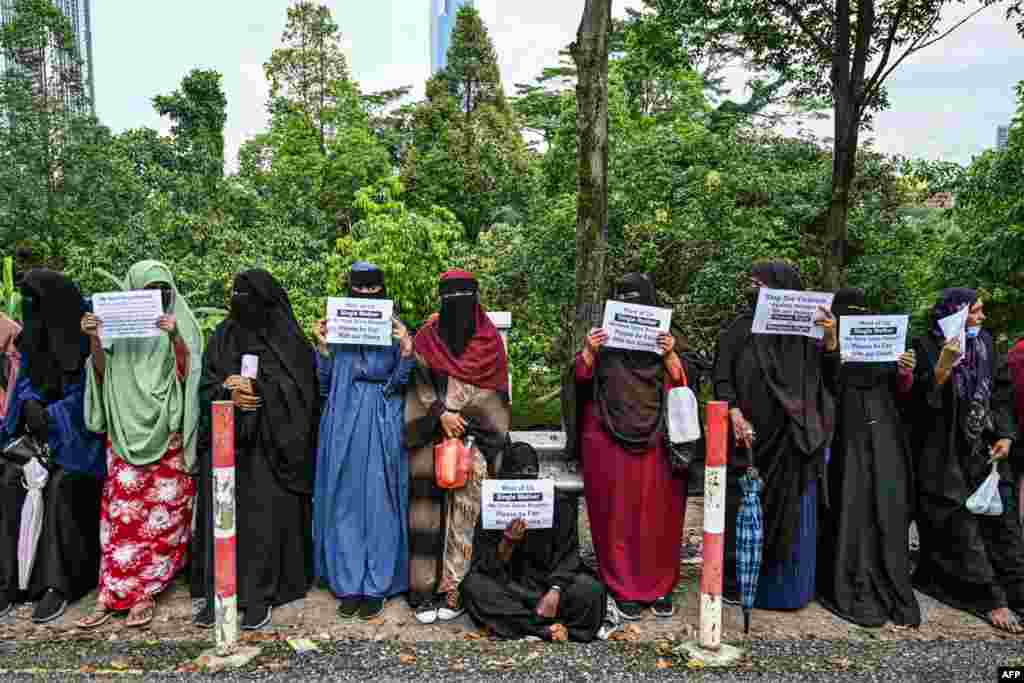 Somali's women refugees hold placards as they gather to protest their living conditions in Malaysia, outside the office of the United Nations High Commissioner For Refugees (UNHCR) in Kuala Lumpur.
