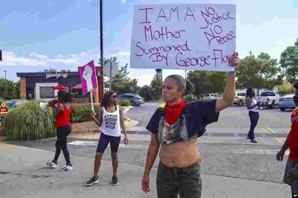 Protestors gather outside the Wendy's fast food restaurant in Atlanta on Saturday, June 13, 2020, where Rayshard Brooks, a 27-year-old black man, was shot and killed by Atlanta police Friday evening during a struggle in a drive-thru line. (Steve Schaefer/