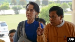 FILE - Myanmar democracy icon Aung San Suu Kyi (L) is escorted by National League for Democracy (NLD) senior leader and lawmaker Zaw Myint Maung (R) as she arrives at the parliament in Naypyidaw on March 1, 2016.