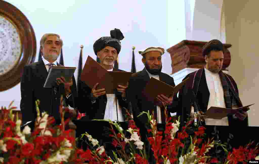 Newly-elected President Ashraf Ghani (2nd left) stands next to Afghanistan's Chief Executive Abdullah Abdullah (left) and his deputies as he takes the oath during his inauguration, in Kabul, Sept. 29, 2014.