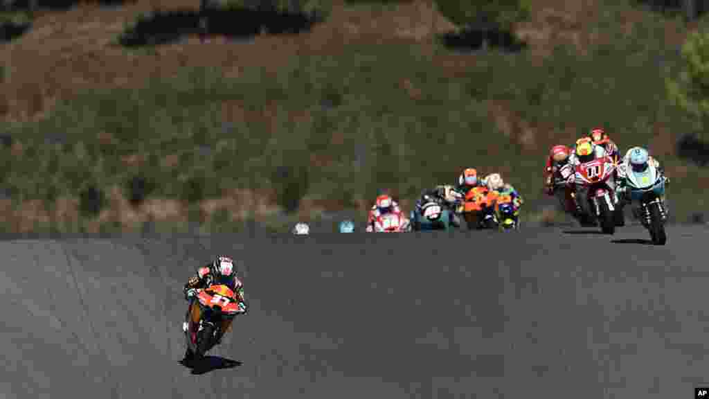 Moto3 rider Pedro Acosta of Spain, left, steers his motorcycle followed by Dennis Foggia of Italy, right, during the Algarve Motorcycle Grand Prix, at the Algarve International circuit near Portimao, Portugal.
