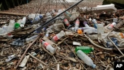 Plastic bottles and other plastics lie washed up on the north bank of the River Thames in London, Feb. 5, 2018.