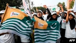 Youths take part in a protest rally in Lahore, Pakistan, Oct. 27, 2019, to mark "Black Day" in support of the people living in India-administered Kashmir.