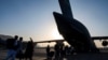 U.S. Air Force airmen guide evacuees aboard a U.S. Air Force C-17 Globemaster III at Hamid Karzai International Airport in Kabul, Afghanistan, Aug. 24, 2021, in this image provided by the U.S. Air Force.