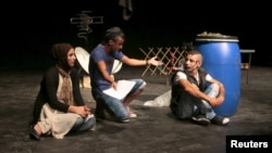 Youths from Tripoli, north Lebanon, perform in the play, "Love and War on the Rooftops," in Beirut, Lebanon, July 28, 2015. 