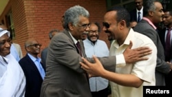 FILE - Ethiopian Prime Minister Abiy Ahmed, right, meets members of Sudan's opposition alliance to mediate in its political crisis at the Ethiopian Embassy in Khartoum, Sudan, June 7, 2019.