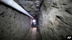 Federal Police officer stands in the tunnel where according to authorities drug lord Joaquin "El Chapo" Guzman made his escape from the Altiplano maximum security prison in Almoloya, west of Mexico City, July 16, 2015. 