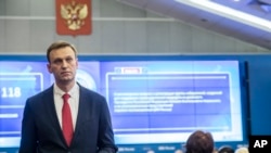 FILE - Russian opposition leader Alexei Navalny stands at Russia's Central Election commission in Moscow, Russia, Dec. 25, 2017.