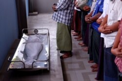 FILE - Muslim men pray during the funeral of 7-year-old Khin Myo Chit who was shot at her home during protests against military coup in Mandalay, Myanmar, March 24, 2021.