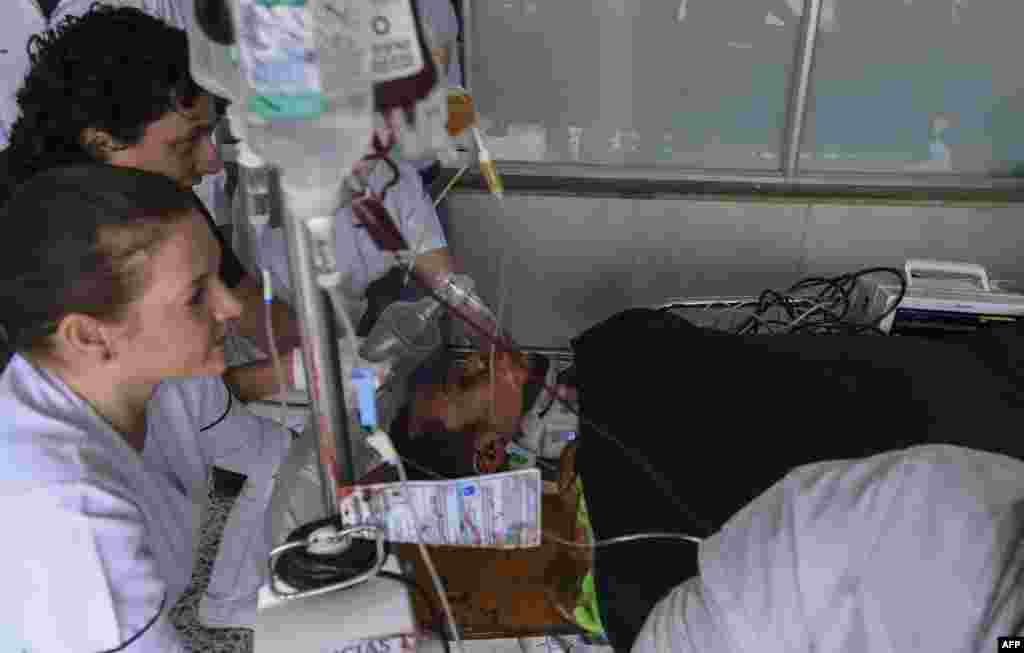Brazil's Chapecoense player Helio Neto is helped by paramedics at the San Juan de Dios clinic in La Ceja, Antioquia Department, Colombia.