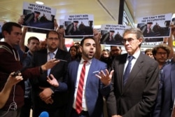 Omar Shakir, Human Rights Watch's Israel and Palestine director, stands next to Ken Roth, executive director of HRW, before departing Israel at Ben Gurion International Airport, near Tel Aviv, Israel, Nov. 25, 2019.