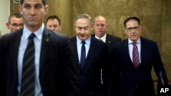 Israeli Prime Minister Benjamin Netanyahu (C) arrives for a weekly cabinet meeting, in Jerusalem, Jan. 1, 2017. On Sunday Israel's security cabinet decided not to return the bodies of killed Hamas militants as the group is refusing to return the bodies of two killed Israeli soldiers.