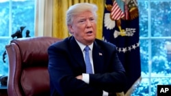 FILE - U.S. President Donald Trump speaks at the White House in Washington, Jan. 17, 2018. 