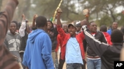 FILE - Protesters clash with Zimbabwean police in Harare, July, 4, 2016. 