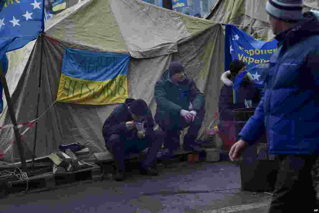 Protesters eat at their tent camp in Independence Square in Kyiv, Dec. 5, 2013.