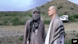 FILE: Image taken from video obtained website shows Sgt. Bowe Bergdahl, right, stands with a Taliban fighter in eastern Afghanistan, May 31, 2014.