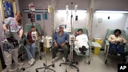 Cancer patients receive chemotherapy at Parkland Memorial Hospital in Dallas. A new, experimental treatment for lymphoma could allow patients to forgo the often agonizing ordeal of chemotherapy. (AP Photo/Tony Gutierrez)