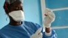 A healthcare worker from the World Health Organization prepares vaccines to give to front line aid workers, in Mbandaka, Dec. 5, 2019 .