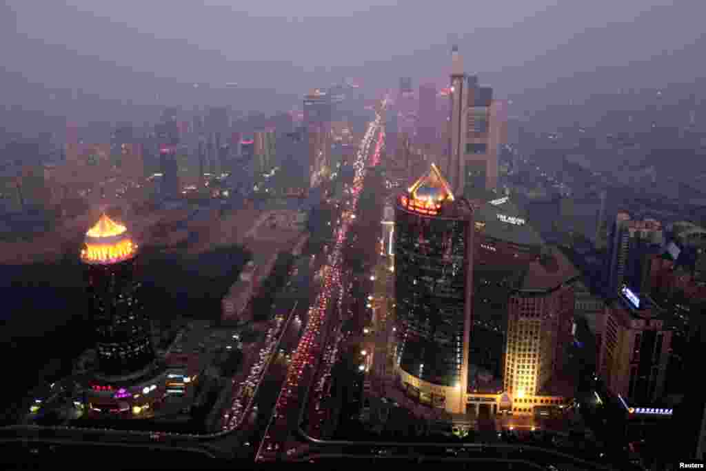 Buildings in Beijing are pictured on an evening with heavy haze and smog, October 28, 2011.