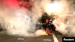  A fire burns on the street during protests after the 'not guilty' verdict was announced in the trial of Kyle Rittenhouse, in Portland, Oregon, Nov. 19, 2021, in this still image obtained from a social media video. (Grace Morgan/via Reuters)