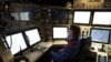 A French navy worker looks at screens in the navigation and operations center in the new French nuclear-powered submarine "Suffren" in Cherbourg, north-western France, July 12, 2019. 