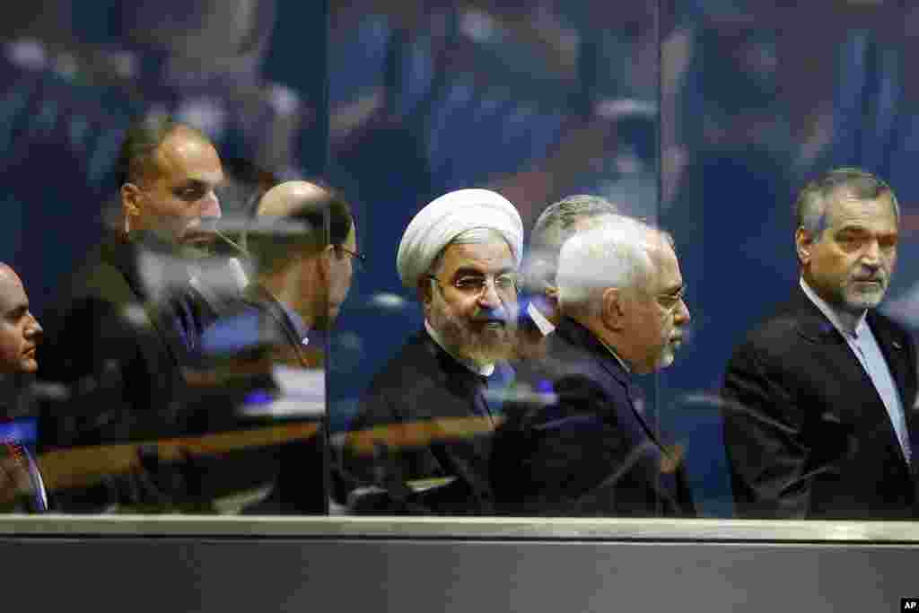 President Hassan Rouhani of Iran (center) walks with Iranian Foreign Minister Mohammad Javad Zarif, second right, as he leaves after addressing the 69th session of the United Nations General Assembly at U.N. headquarters, New York, Sept. 25, 2014.