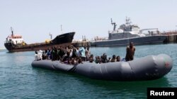 Illegal migrants arrive in a dinghy at a naval base after they were rescued by Libyan coastguard in the coastal city of Tripoli, Libya, May 6, 2017. 