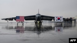 National flags of the US and South Korea are displayed in front of a B-52H strategic bomber parked at a South Korean Air Force base at Cheongju Airport on Oct. 19, 2023.